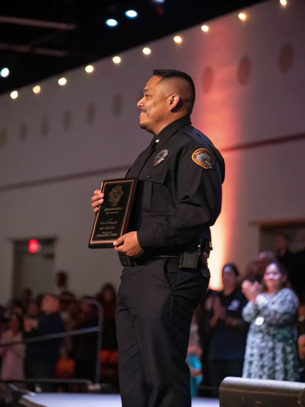 A security guard receives a certificate of achievement from a supervisor, symbolizing career advancement and recognition within the company.